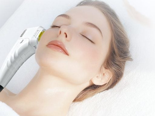 HIFU facial treatment being performed with a clinic HIFU machine handpiece